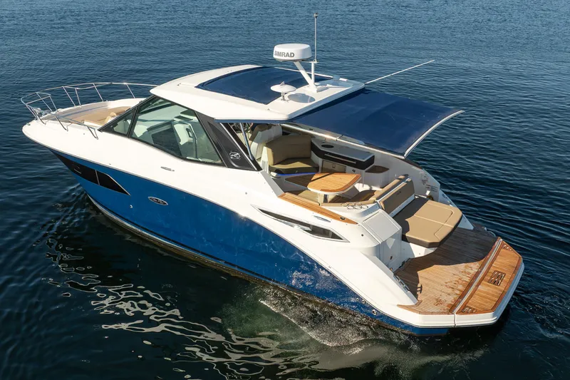 Slide: The Image of 2020 Sea Ray Sundancer 320 Coupe cruising on calm blue waters. - 8