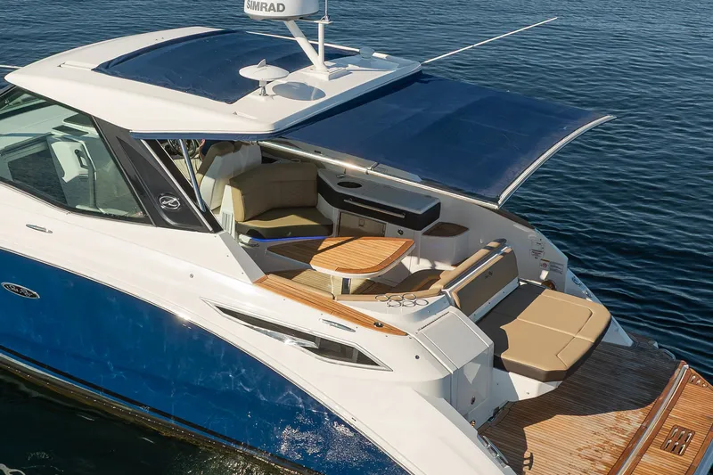 Slide: The Image of 2020 Sea Ray Sundancer 320 Coupe with spacious deck and seating on calm water. - 9