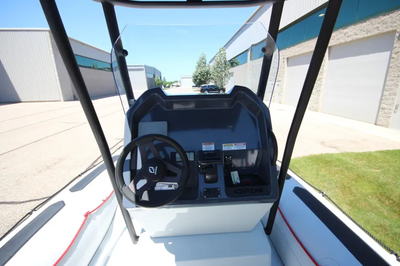 Slide: The Image of 2020 Zodiac Open 6.5 boat console with steering wheel and controls. - 13