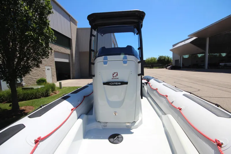Slide: The Image of 2020 Zodiac Open 6.5 boat with sleek design, docked outdoors. - 17