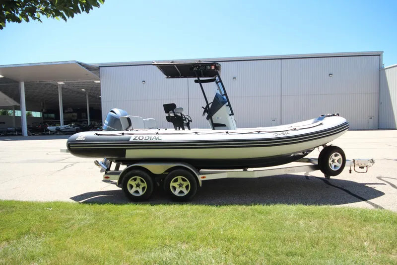 Slide: The Image of 2020 Zodiac Open 6.5 boat on trailer, parked outdoors near a building. - 5