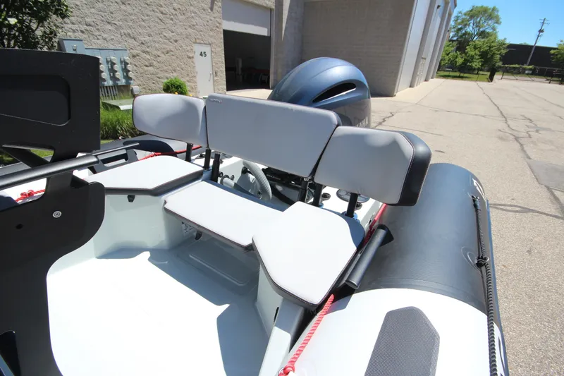 Slide: The Image of 2020 Zodiac Open 6.5 boat interior with seating and Yamaha engine in a sunny outdoor setting. - 9