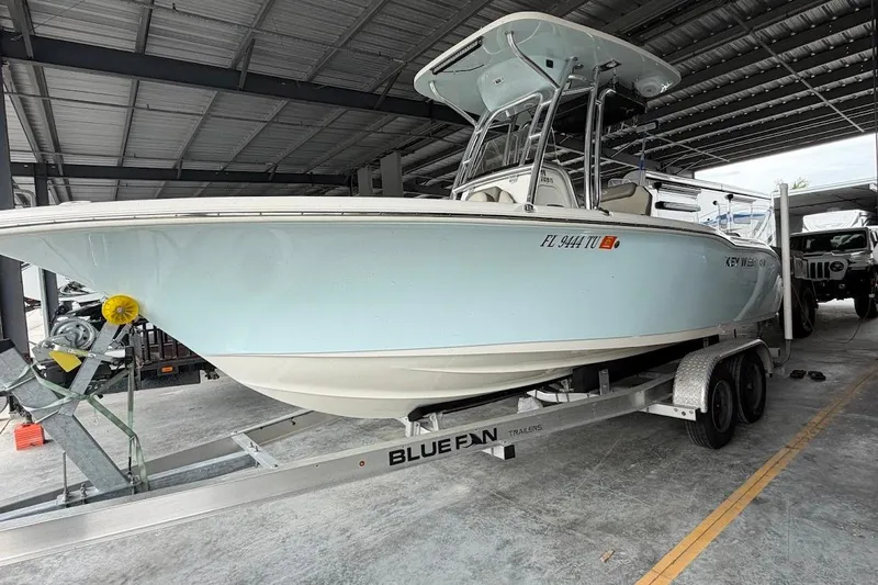 The Image of 2024 Key West 219 FS boat on trailer in covered storage area. - 0