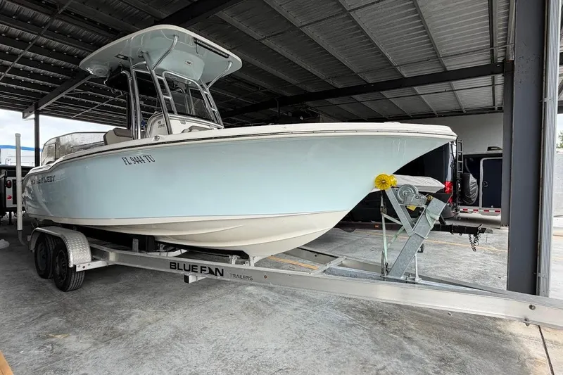 Slide: The Image of 2024 Key West 219 FS boat on trailer in covered storage area. - 1