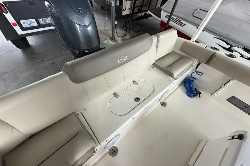 Slide: The Image of 2024 Key West 219 FS boat interior with seating and storage compartments. - 13