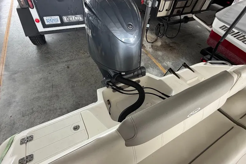 Slide: The Image of 2024 Key West 219 FS boat with Yamaha outboard motor in storage. - 5