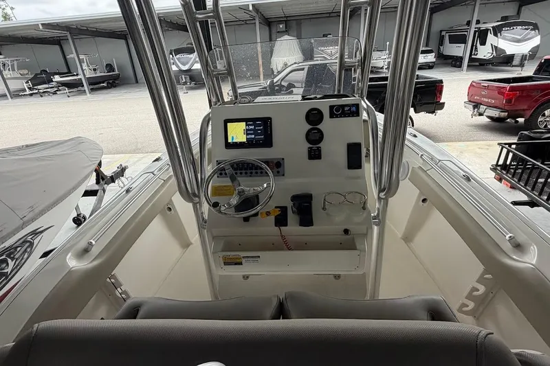 Slide: The Image of 2024 Key West 219 FS boat console with steering wheel and navigation display. - 7