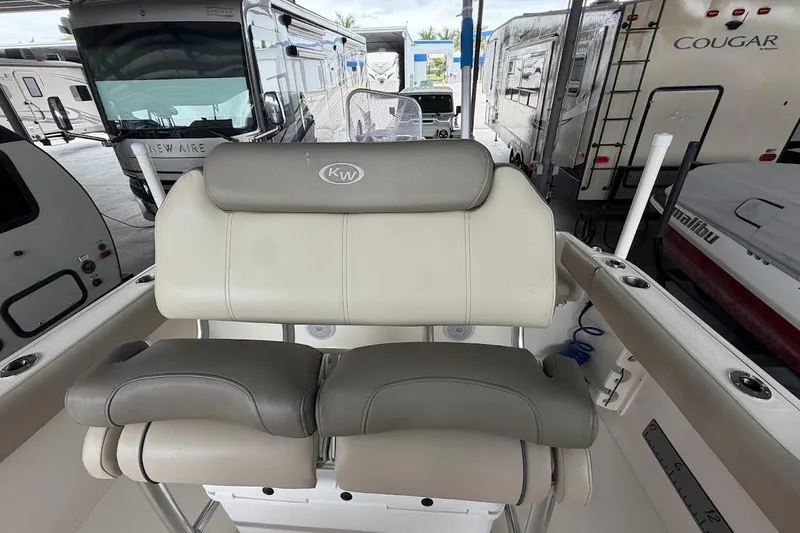 Slide: The Image of 2024 Key West 219 FS boat seat with RVs in background at dealership. - 8