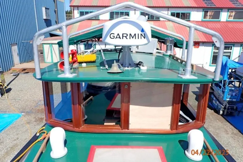 Slide: The Image of 1961 William Garden Custom boat with Garmin equipment, docked near industrial buildings. - 3