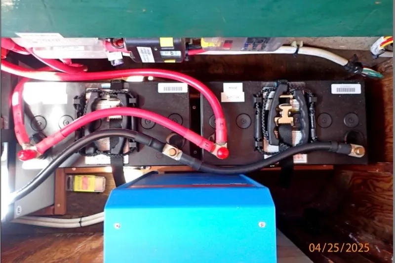 Slide: The Image of Battery setup in a 1961 William Garden Custom boat, featuring red and black cables. - 6