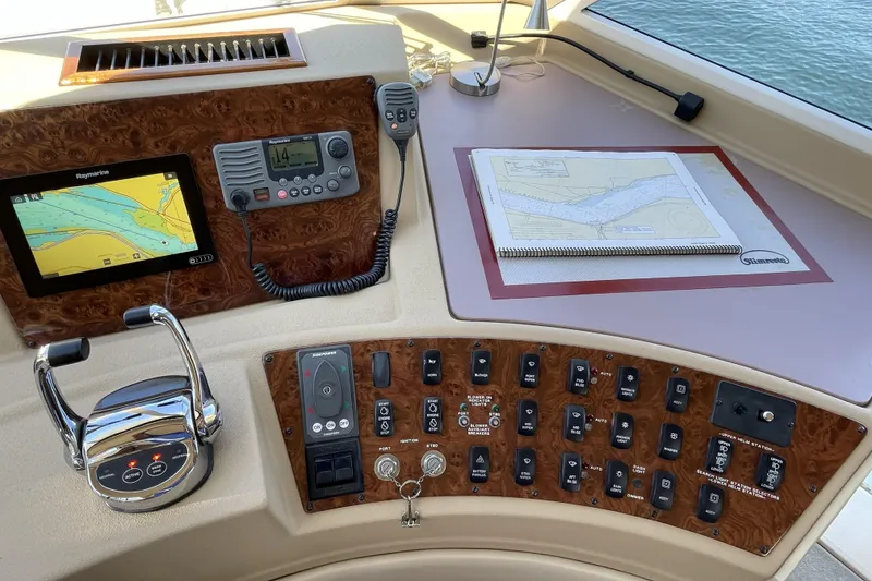 Slide: The Image of Pilothouse controls of a 2008 Meridian 490, featuring navigation equipment and a nautical chart. - 10
