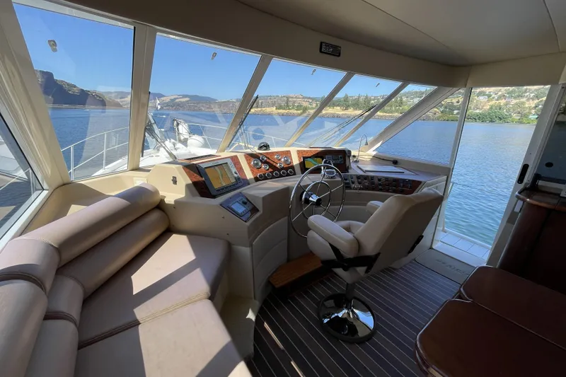Slide: The Image of Interior of a 2008 Meridian 490 Pilothouse yacht with panoramic windows and helm. - 11