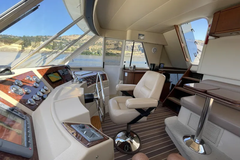 Slide: The Image of Pilothouse interior of 2008 Meridian 490 yacht with steering wheel and navigation controls. - 13