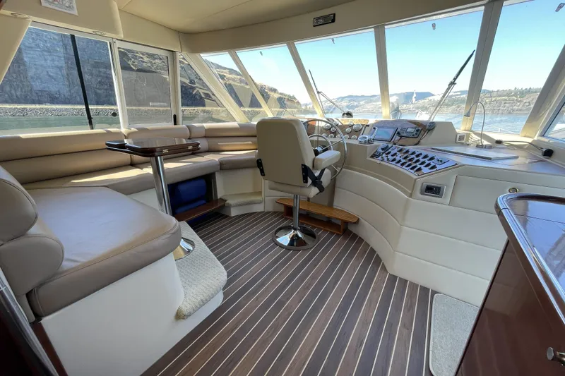 Slide: The Image of Pilothouse interior of 2008 Meridian 490, featuring helm, seating, and panoramic windows. - 14