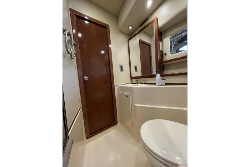 Slide: The Image of Luxurious bathroom in 2008 Meridian 490 Pilothouse yacht, featuring elegant wood accents and modern fixtures. - 19