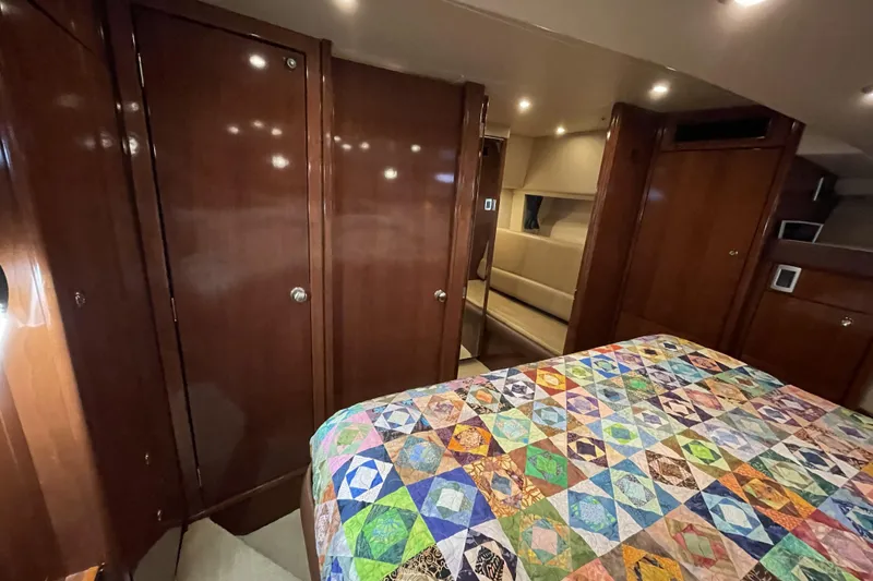 Slide: The Image of Luxurious 2008 Meridian 490 Pilothouse interior with colorful quilt and polished wood finishes. - 24