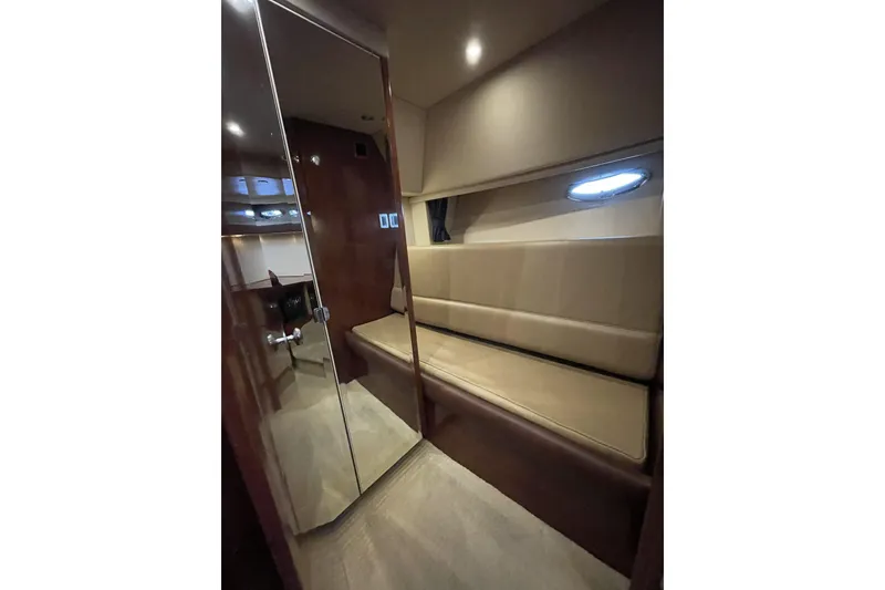 Slide: The Image of Interior of 2008 Meridian 490 Pilothouse with beige seating and wooden accents. - 25