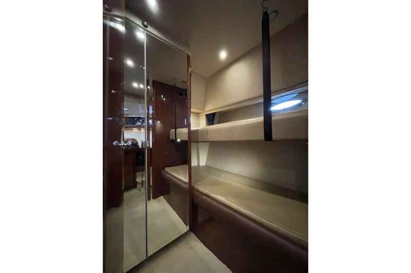 Slide: The Image of 2008 Meridian 490 Pilothouse interior with bunk beds and sleek wooden finishes. - 26