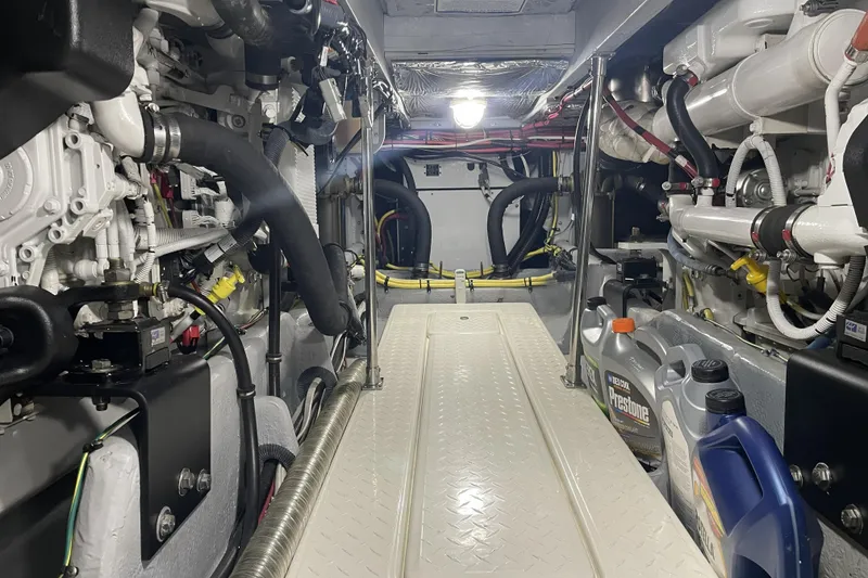 Slide: The Image of Engine room of a 2008 Meridian 490 Pilothouse yacht, showcasing machinery and maintenance supplies. - 29