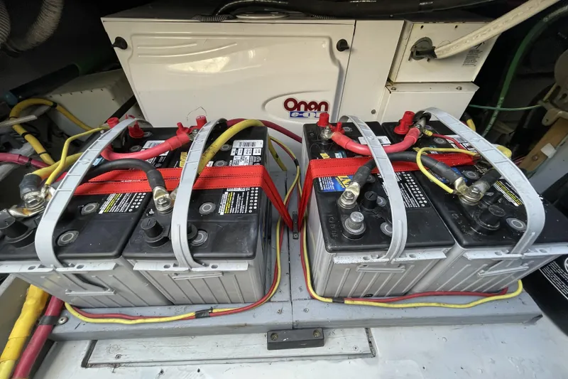Slide: The Image of Battery setup in a 2008 Meridian 490 Pilothouse engine room with Onan generator. - 33