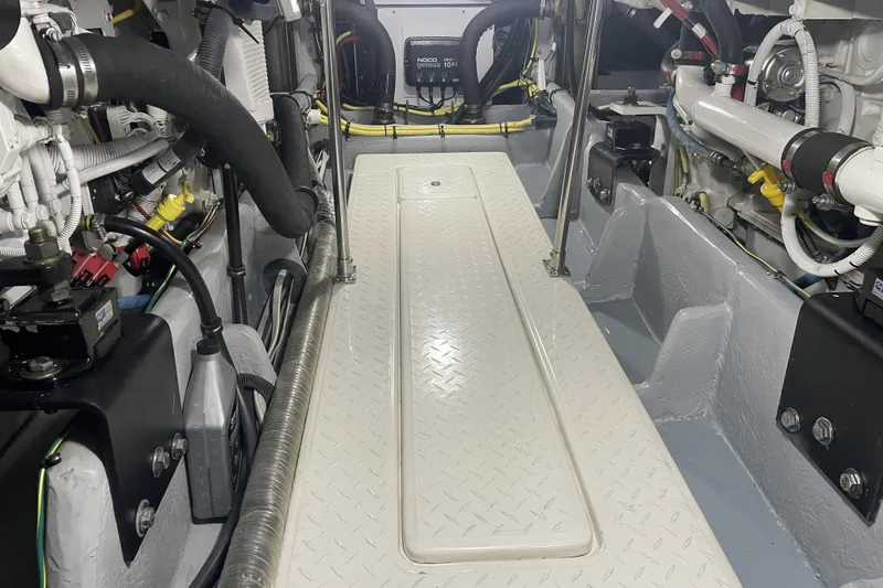 Slide: The Image of Engine room of a 2008 Meridian 490 Pilothouse, showcasing mechanical components and wiring. - 34