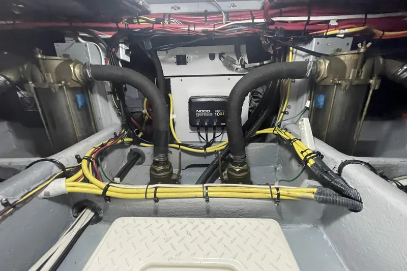 Slide: The Image of Engine room of a 2008 Meridian 490 Pilothouse with wiring and hoses visible. - 37