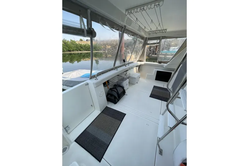 Slide: The Image of 2008 Meridian 490 Pilothouse interior with spacious seating and scenic water view. - 41