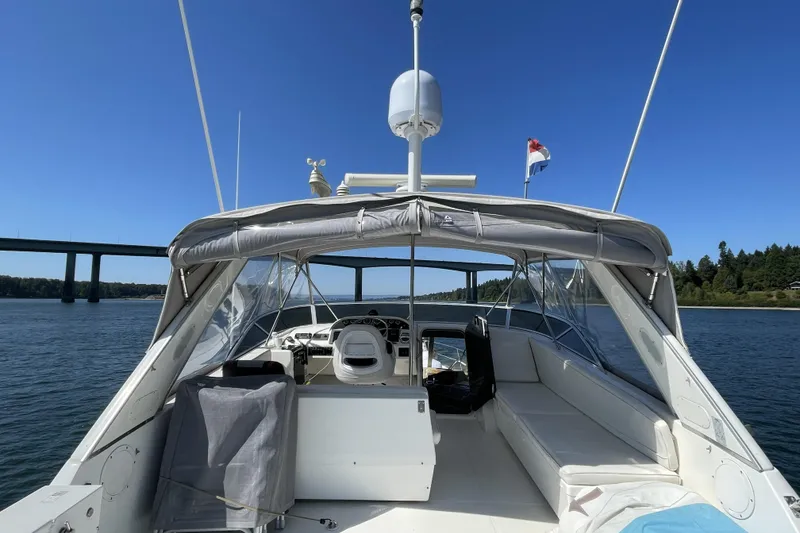Slide: The Image of 2008 Meridian 490 Pilothouse yacht on water, bridge in background, clear blue sky. - 45
