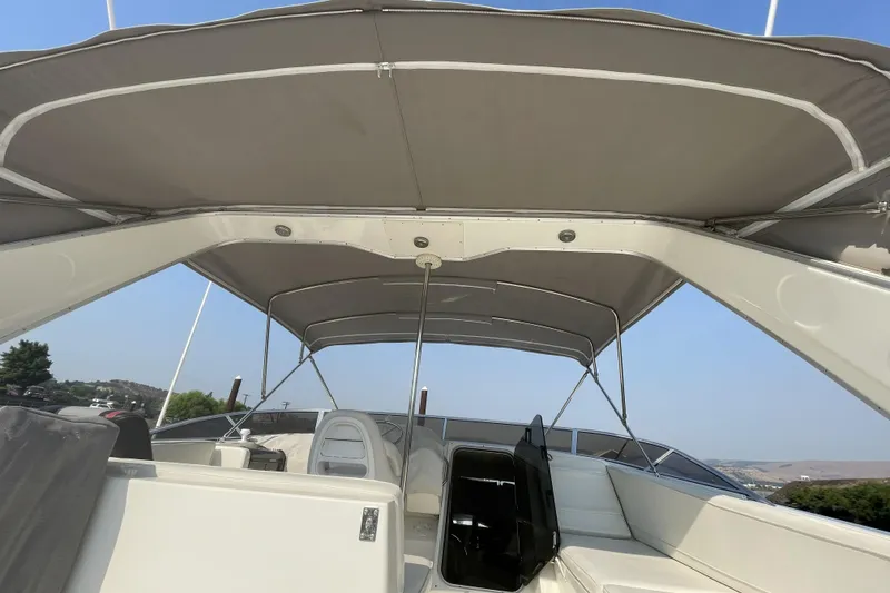 Slide: The Image of 2008 Meridian 490 Pilothouse boat interior with canopy, showcasing seating and helm area. - 46