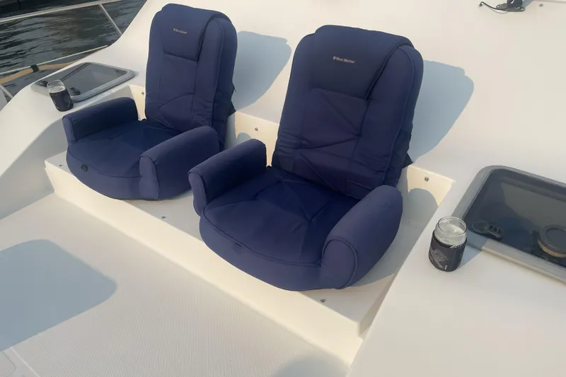 Slide: The Image of Two blue cushioned seats on a 2008 Meridian 490 Pilothouse boat deck. - 47