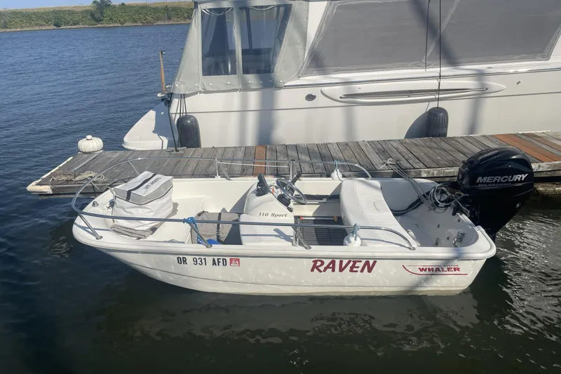 Slide: The Image of Small boat named "Raven" docked beside a 2008 Meridian 490 Pilothouse. - 48