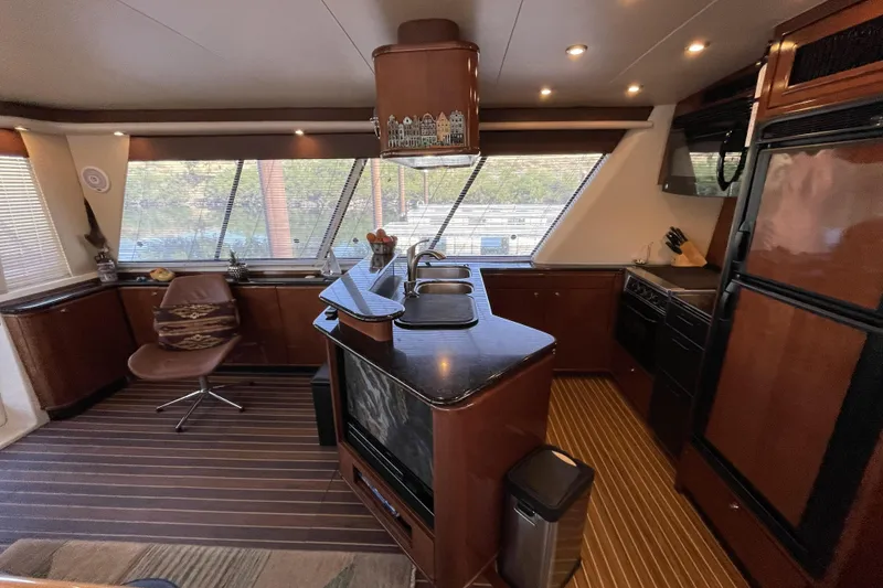 Slide: The Image of Luxurious interior of a 2008 Meridian 490 Pilothouse yacht with modern kitchen amenities. - 5