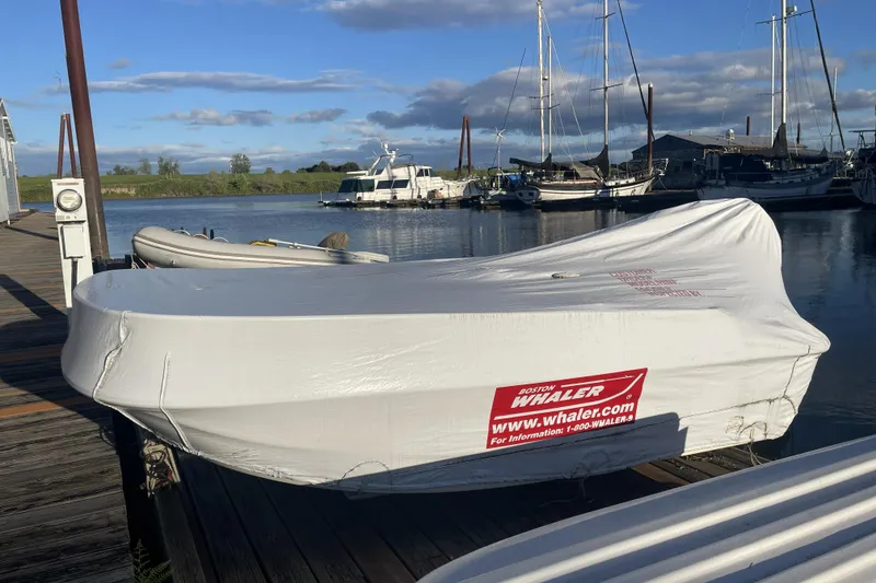 Slide: The Image of Covered Boston Whaler boat docked near a 2008 Meridian 490 Pilothouse yacht. - 50