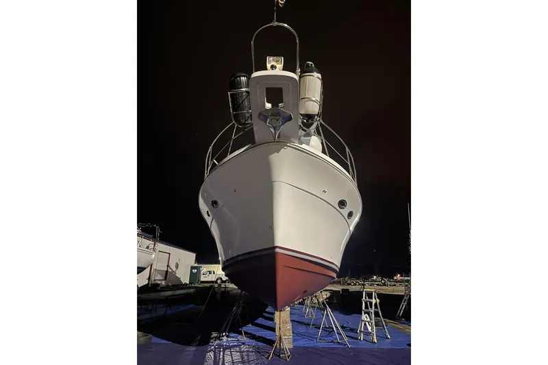 Slide: The Image of 2008 Meridian 490 Pilothouse yacht on dry dock at night, front view. - 54