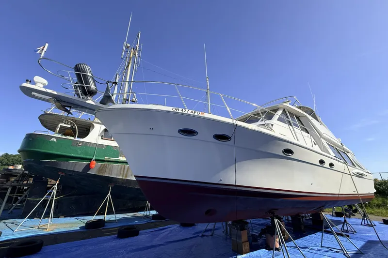 Slide: The Image of 2008 Meridian 490 Pilothouse yacht on dry dock, blue sky background. - 55