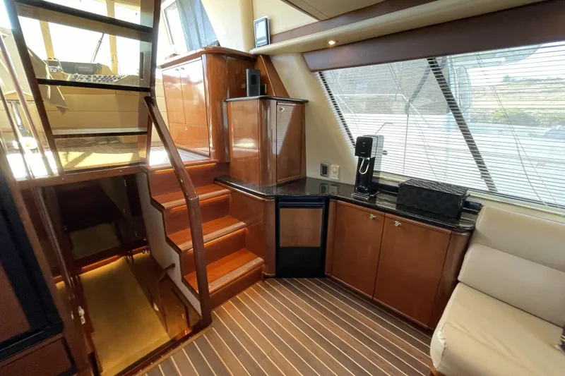 Slide: The Image of Luxurious interior of 2008 Meridian 490 Pilothouse yacht with wooden cabinetry and seating. - 6