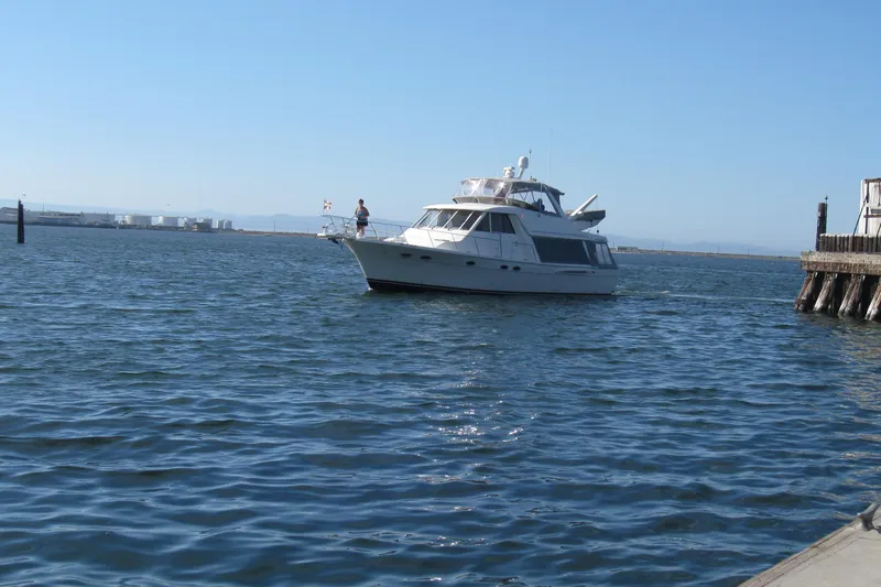 Slide: The Image of 2008 Meridian 490 Pilothouse yacht cruising near a dock on a sunny day. - 62
