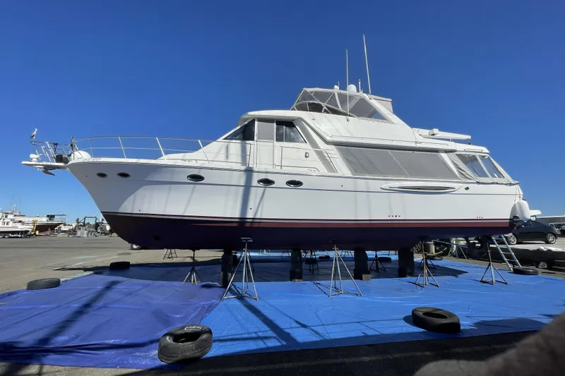Slide: The Image of 2008 Meridian 490 Pilothouse yacht on stands, displayed outdoors under clear blue sky. - 63