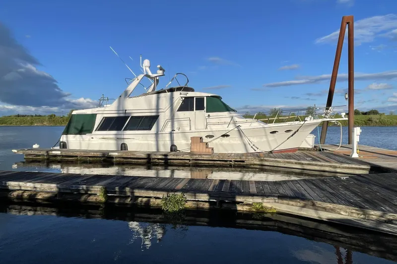 Slide: The Image of 2008 Meridian 490 Pilothouse yacht docked on a sunny day, surrounded by calm waters. - 67