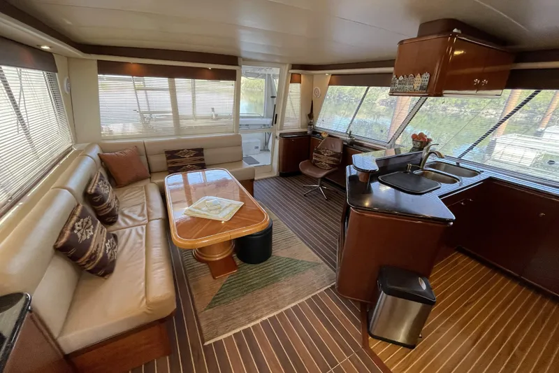 Slide: The Image of Luxurious interior of a 2008 Meridian 490 Pilothouse yacht with elegant seating and kitchen area. - 76