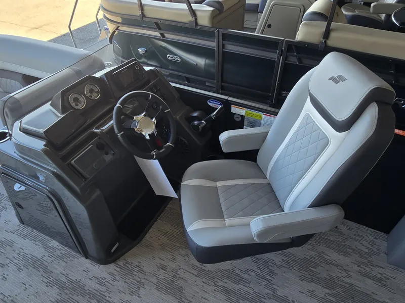 Slide: The Image of The image shows the helm of a 2027 Starcraft EXS 1 Q DH with a gray seat. - 14