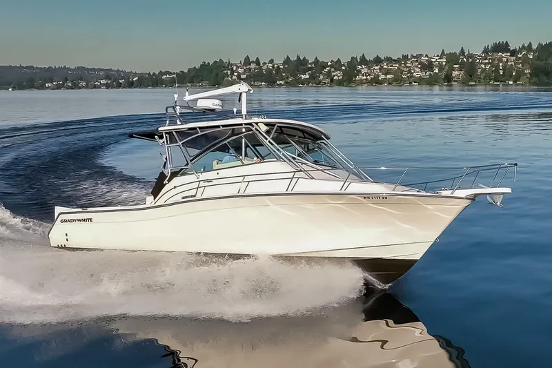 Slide: The Image of 2006 Grady-White Express 360 cruising on a serene lake with scenic background. - 1