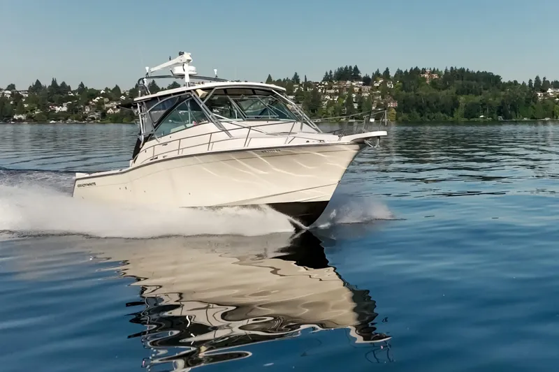 Slide: The Image of 2006 Grady-White Express 360 cruising on a serene lake with scenic background. - 11