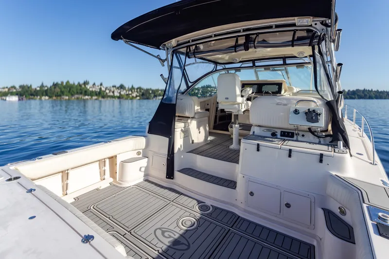 Slide: The Image of 2006 Grady-White Express 360 boat interior on calm lake, showcasing seating and helm. - 14