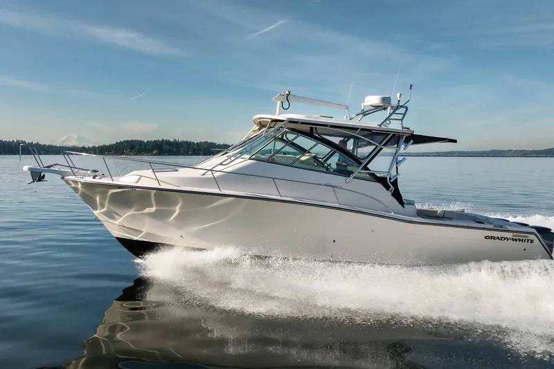 Slide: The Image of 2006 Grady-White Express 360 cruising on calm waters under a clear blue sky. - 2