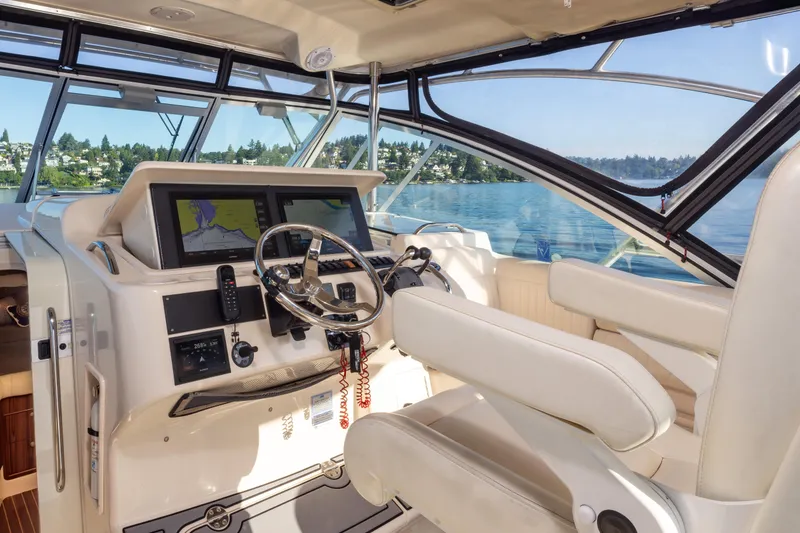 Slide: The Image of 2006 Grady-White Express 360 helm with navigation screens, steering wheel, and lake view. - 20