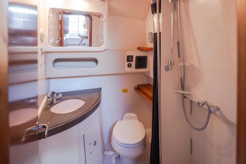 Slide: The Image of 2006 Grady-White Express 360 boat bathroom with sink, toilet, and shower. - 29