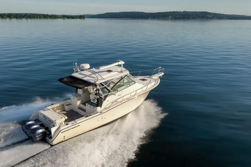 Slide: The Image of 2006 Grady-White Express 360 cruising on calm waters, showcasing sleek design and powerful engines. - 3
