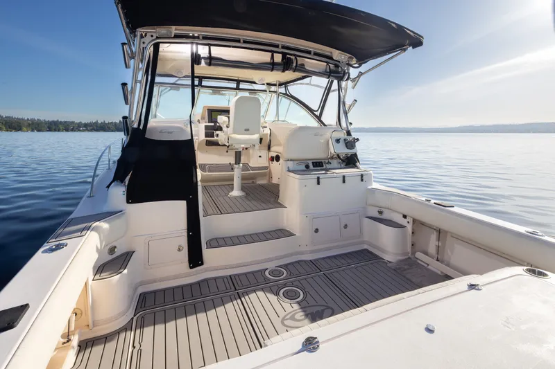 Slide: The Image of 2006 Grady-White Express 360 boat interior with seating, helm, and open deck on calm water. - 33