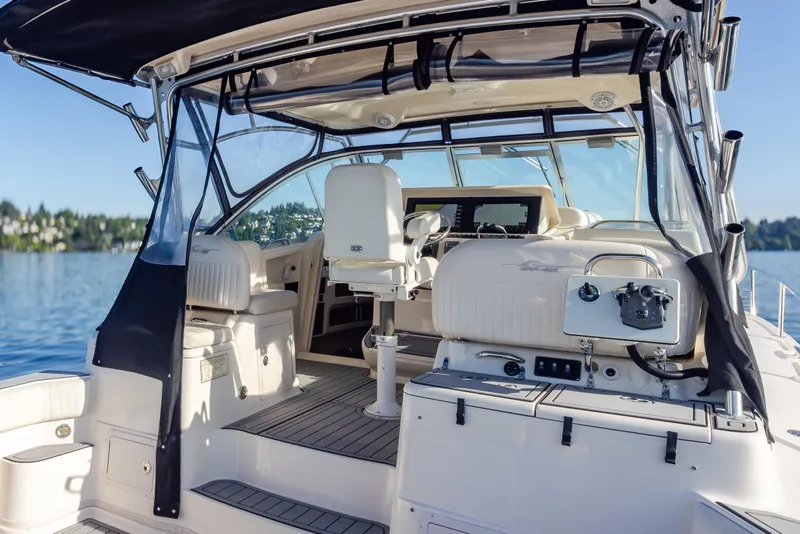 Slide: The Image of 2006 Grady-White Express 360 boat interior with helm, seating, and clear canopy on a sunny day. - 34